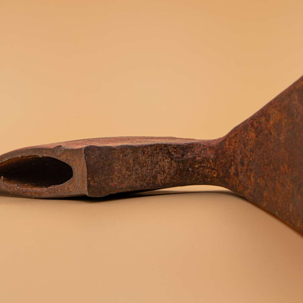 Close-up of the Pulaski grub hoe eye and blade profile showing original forged construction.